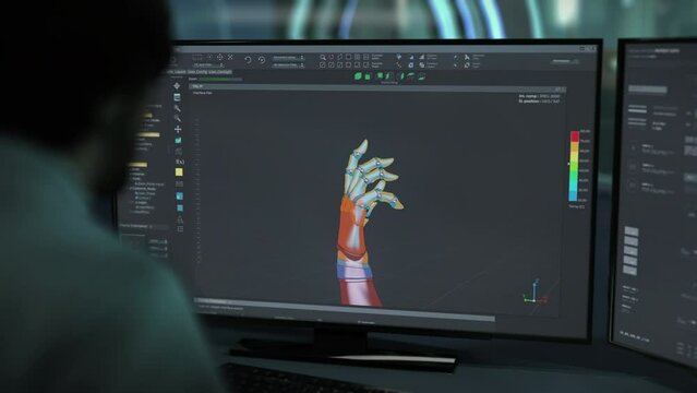 Specialist Uses 3d Modeling Software To Create Design Of Future Robotic Arm. Innovative 3D Modeling. Designing Cyberware. Desktop 3D Modeling. New Technology Design. Prototype Assembly