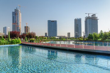 Contemporary buildings reflected in pool of Tashkent City Park