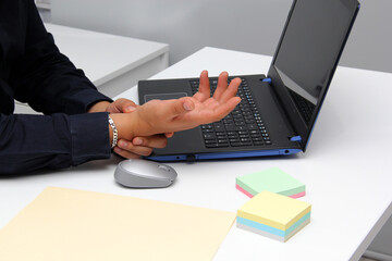 Adult Latin man suffering from pain, tingling, numbness and weakness in his wrist due to Carpal...