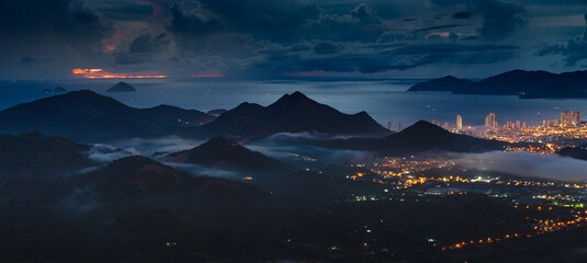 Panorama of the coastal city of Nha Trang with brilliant lights, seen from the top of a high mountain in Vinh Phuong commune, Nha Trang City, Khanh Hoa province, Vietnam