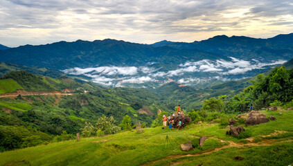 A female tourist plays with ethnic minority children in the high mountains in Nam Tra My District, Quang Nam Province, Vietnam  