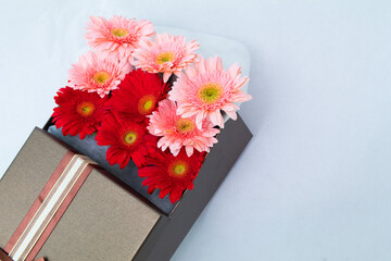 A bunch of flowers in a beautiful gift box, Barberton. daisy,rose multi-colored