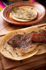 Roast meat tacos with Chorizo. Very popular dish in northern Mexico, also called Carne Asada, Asado, Discada or Parrillada, is a cooking technique in which food is exposed to the heat of the embers.