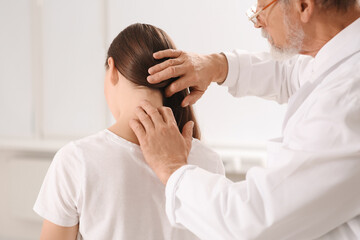 Fototapeta na wymiar Professional orthopedist examining patient's neck in clinic, closeup