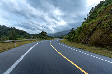 Curved road down to mountain. Many warning sign indicating for safety