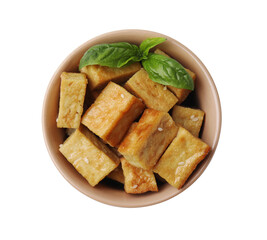 Delicious fried tofu, basil and sesame seeds in bowl isolated on white, top view