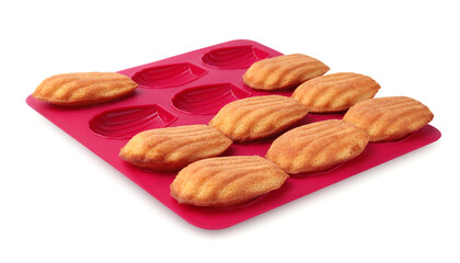 Many tasty madeleine cookies in baking mold isolated on white