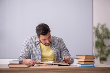 Young male student in front of whiteboard