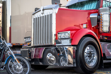 Truck driver own not only red classic big rig semi truck but also a motorcycle for travel during...