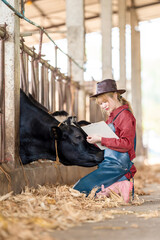 Industry, agriculture, agriculture, people and animal husbandry concept - veterinarian or doctor with clipboard and herd of cows in dairy farm