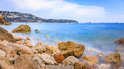 Fototapeta na wymiar Mediterranean Sea and a pebble beach, Roquebrune Cap Martin, France near Monaco