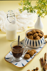 coffee milk in glass with cookies in bowl