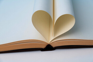 Book pages curved into heart shape