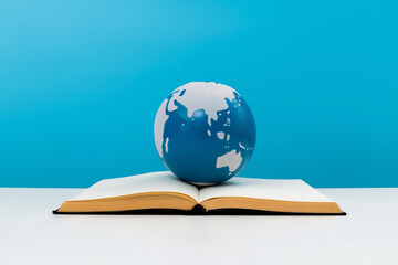 Earth globe on open book