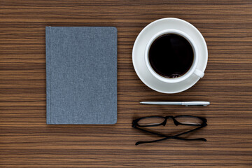 Book with coffee cup and reading glasses