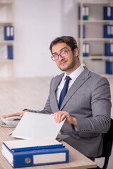 Young male employee working in the office