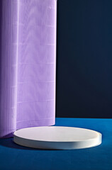 An empty white podium in round shape decorated with light purple paper on dark background. Minimal empty scene of cosmetic products presentation