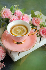 a cup of lemon tea with flowers