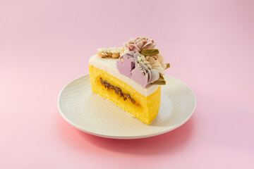 Korean sweet pumpkin rice cake decorated with pretty flowers. Isolated on pink background.
