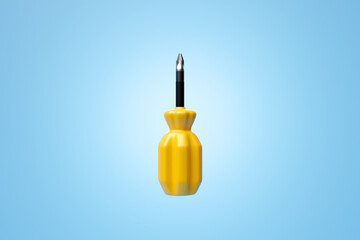 3D illustration of a  yellow crosshead screwdriver hand tool isolated on a monocrome background. 3D...