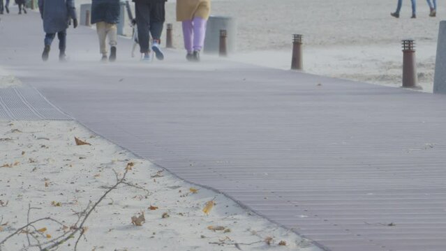 Wind blowing on the boardwalk laid out along the beach.