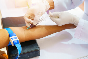 Nurse collecting a blood from patient in hospital