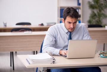 Young male employee working in the office