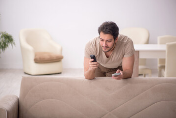 Young man watching tv at home