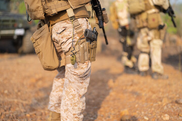 Team of U.S. Army marine corps soldier military war with gun weapon participating and preparing to attack the enemy in Thailand during exercise Cobra Gold training in battle. Combat force.