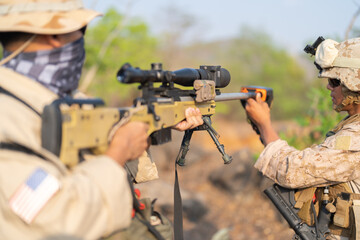 Team of U.S. Army marine corps soldier military war with gun weapon participating and preparing to attack the enemy in Thailand during exercise Cobra Gold training in battle. Combat force.