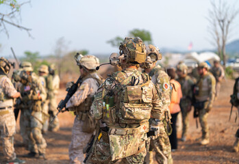 Team of U.S. Army marine corps soldier military war with gun weapon participating and preparing to attack the enemy in Thailand during exercise Cobra Gold training in battle. Combat force.