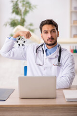 Young male doctor studying molecular model