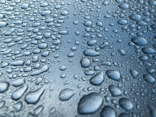 close up drops of water on a car