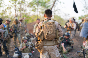Team of U.S. Army marine corps soldier military war with gun weapon participating and preparing to attack the enemy in Thailand during exercise Cobra Gold training in battle. Combat force. © tampatra