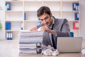 Young male employee in brainstorming concept