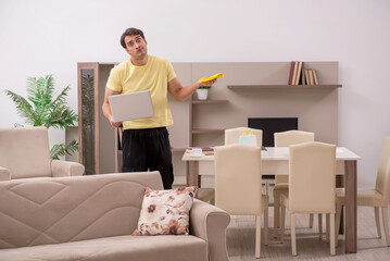 Young man doing housework indoors