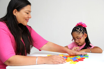 4-year-old Latina girl takes child therapy with the psychotherapist through games to treat her...