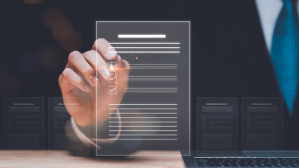 Businessman checking the steps through document with a list of checkboxes ,regulation ,Concepts of practices and policies , procedure company articles of association Terms and Conditions