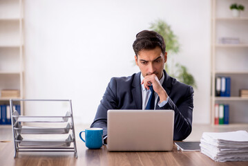 Young male employee working in the office