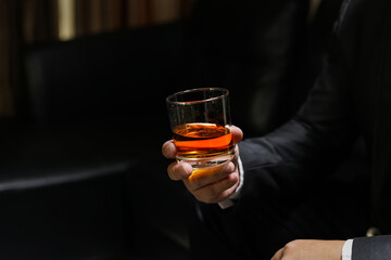 businessmen holding a glass of whiskey