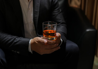 businessmen holding a glass of whiskey