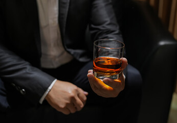 businessmen holding a glass of whiskey