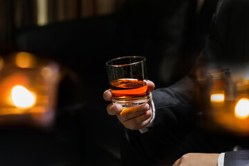 businessmen holding a glass of whiskey