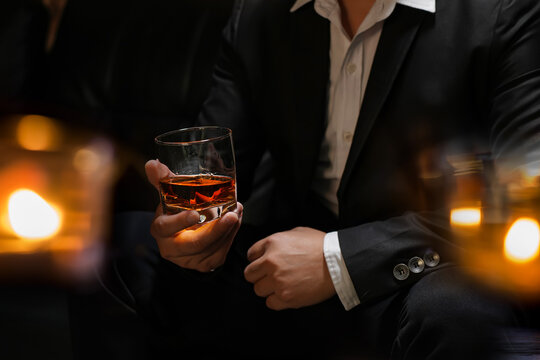 businessmen holding a glass of whiskey