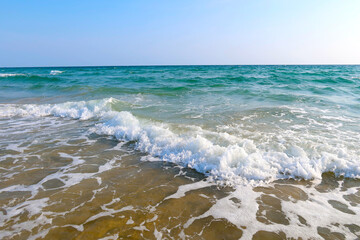 Fototapeta na wymiar Beach with wave and blue sea water background
