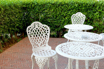 white chairs and table in lawn of garden