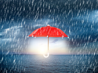 Red umbrella in the rainy sky