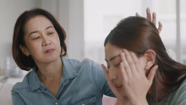 Middle aged asia people old mom love care trust comfort help young teen talk crying stress relief at home. Mum as friend listen adult child woman feel pain sad worry of broken heart life crisis issues