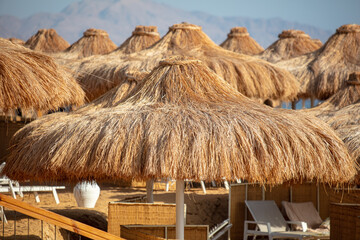 Straw umbrellas on the beach.