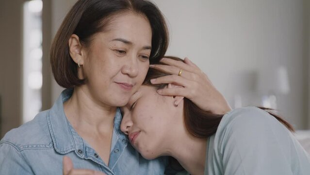 Middle aged asia people old mom love care trust comfort help young teen talk crying stress relief at home. Mum as friend listen adult child woman feel pain sad worry of broken heart life crisis issues